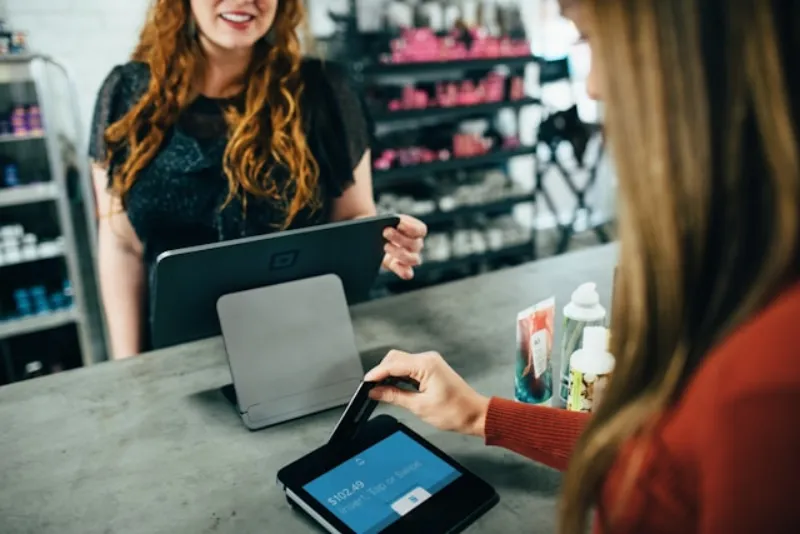Retail customer holding a magnetic store loyalty card